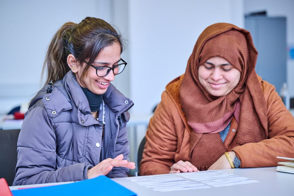 Two female adult learners reading