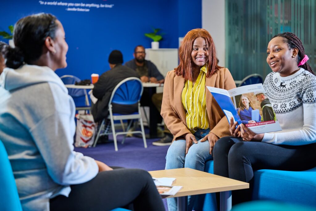 Female adult students talking across table