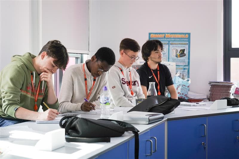 Four male engineering students in lab