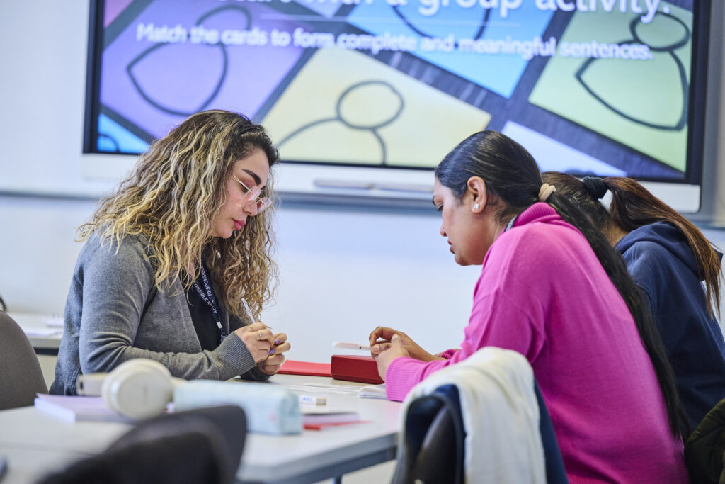 Two students workout out a puzzle