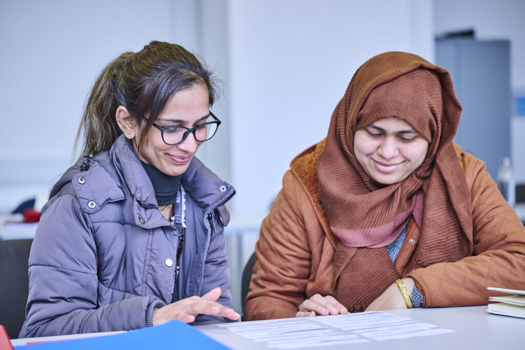 Two adult students working out task